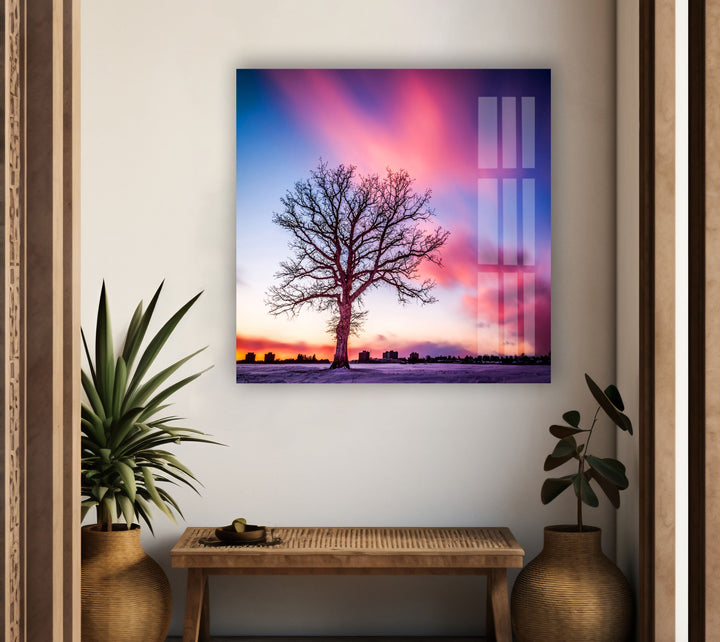 Dreamy glass wall art with a lone tree under a pink and purple sunset.
