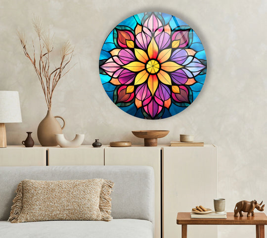 Subtle light defines the shadows cast by the Radiant Harmony multicolor mandala art from glass, illuminating its vivid blues, pinks, and golds on a neutral wall.