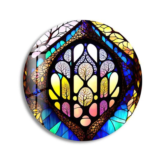 The stained round with intricate tree-like designs is the central subject of this nature-inspired glass wall artwork, rendered in yellow, brown, and blue tones.