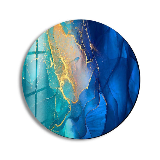 Swirling blues and golds create a dynamic sense of movement in this modern abstract round glass wall art, resembling liquid wall prints frozen in time.