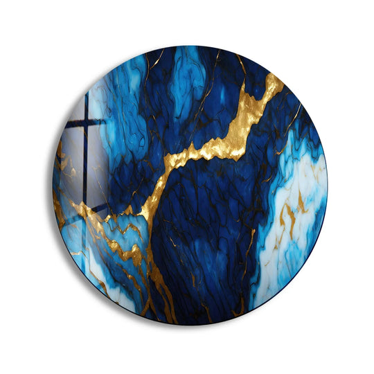 Darkest depths of the royal blue and gold marble luxury round wall art emphasize the mesmerizing art from glass, a modern accent for elegant interiors.