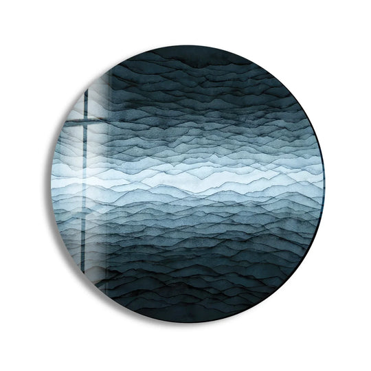 The central subject features an abstract horizon of monochrome layers in this round tempered glass wall art piece, creating a stunning visual effect with white details.