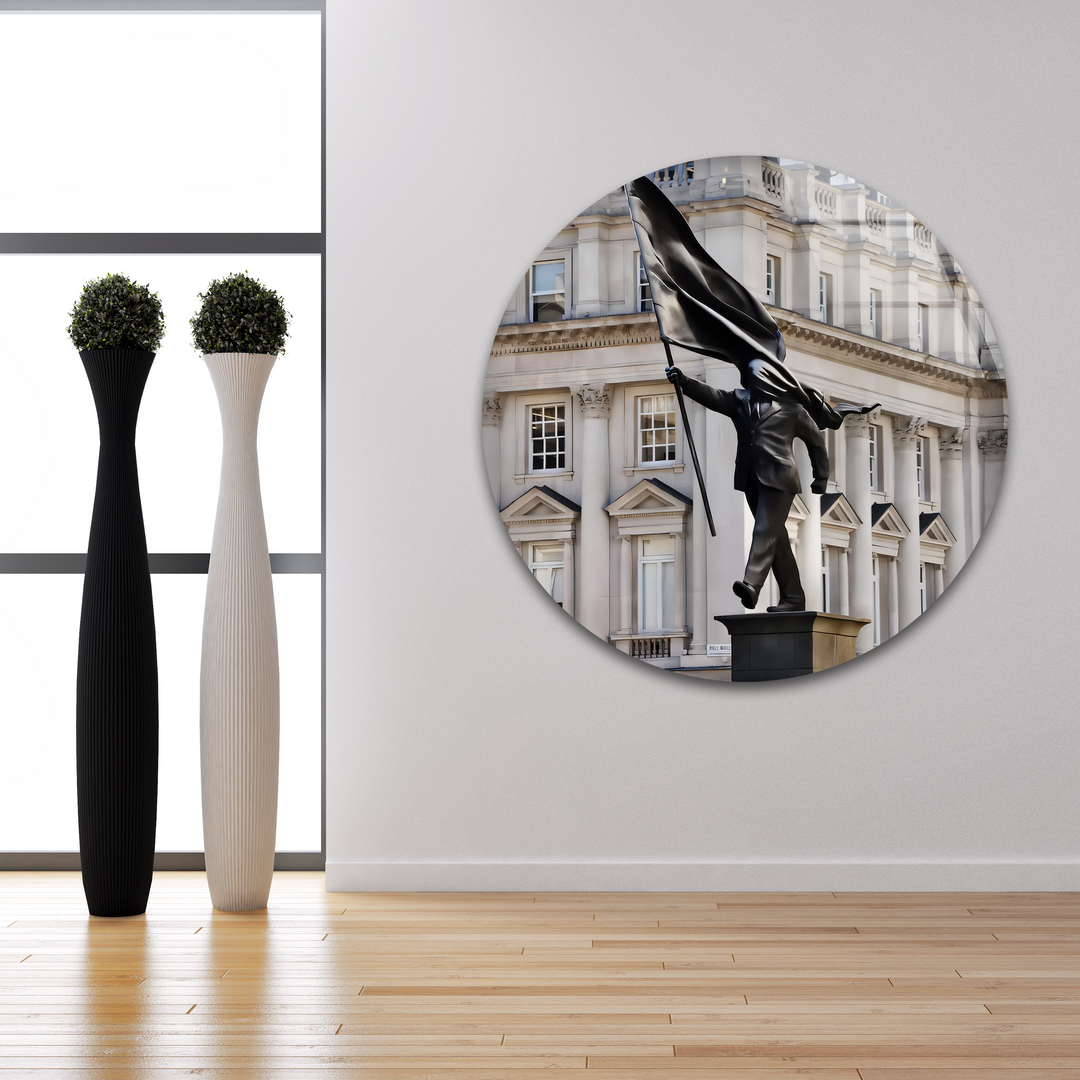 A powerful Banksy 'Stride of Freedom' statue, a figure holding a large flowing flag, vibrantly displayed as best glass art.