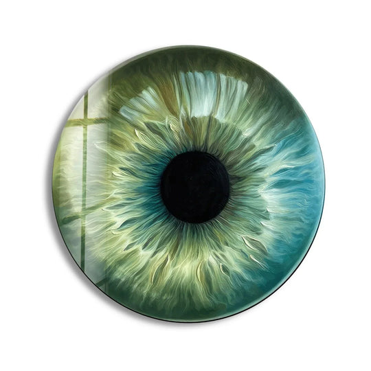 Dominant green and blue hues swirl in this unique modern wall decor featuring a mesmerizing green eye round glass wall art piece.