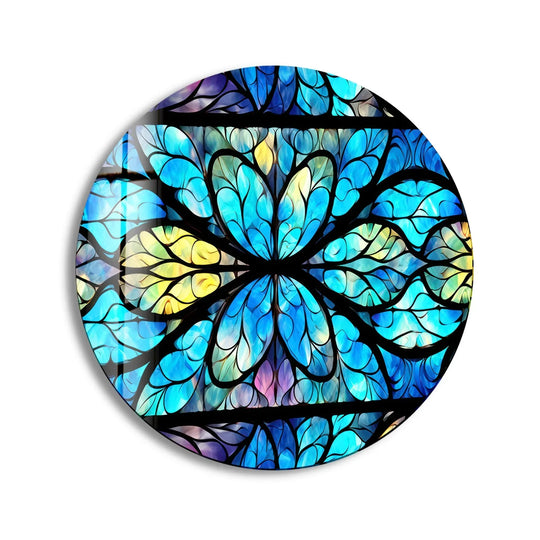 Dominated by cerulean and sky hues, this stained round mandala showcases intricate glass art with black framework forming a symmetrical, floral-like design.