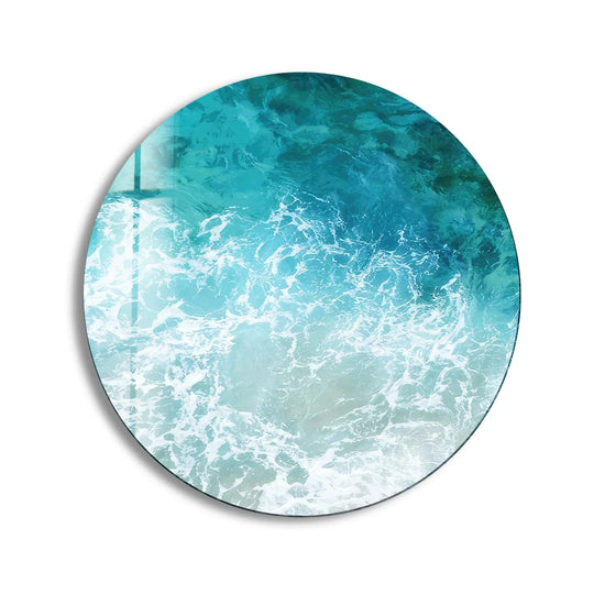 The stillness of this sea waves round glass wall art captures the ocean's might with calming turquoise hues in an exquisite example of art from glass.