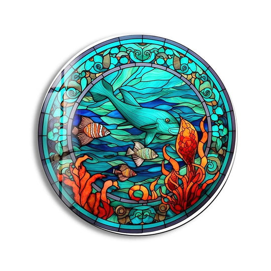 Illuminated by the light, the dolphin's form dominates this stained dolphin and fish round glass wall art, a captivating piece among our vibrant wall art prints.