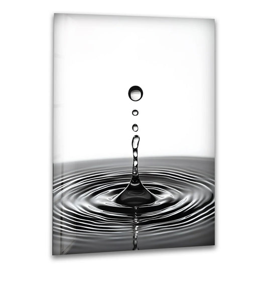 Dominantly monochrome, this glass wall art prints features a striking black-and-white water drop captured in motion.