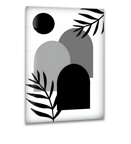 Abstract black and white shapes, including a solid circle and arch forms, are accented by palm leaf silhouettes on this tempered glass wall art.