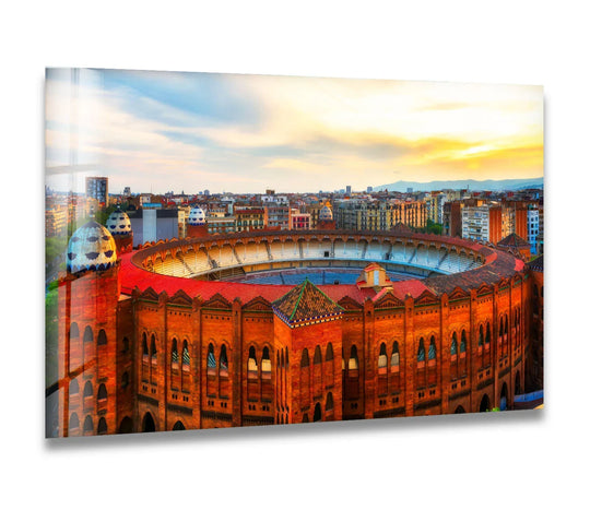 Illuminated by the setting sun, the brightest area of this Arena de Barcelona captures the stunning art from glass featuring the iconic Spanish landmark.