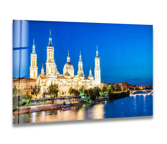 Sleek surface texture of the Basilica del Pilar glass art painting reflects the stunning night view and city lights across the Zaragoza riverfront.