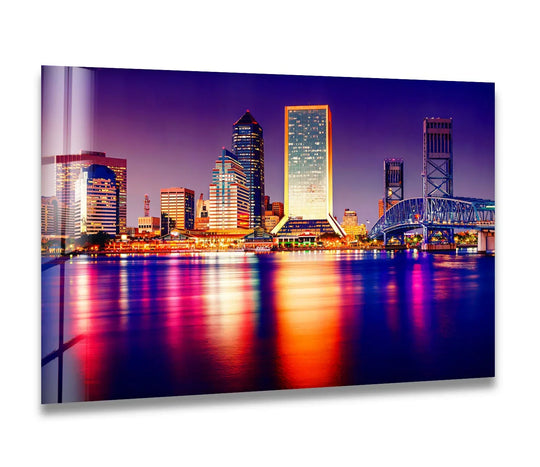 Highlighting the vibrant building facade reflected in the water, this radiant city lights **best glass art** showcases a luminous night skyline.