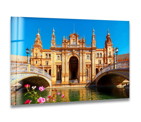 Vivid color contrast highlights the Plaza de España glass wall art, bringing its majestic Spanish landmark and scenic canal into your home decor.