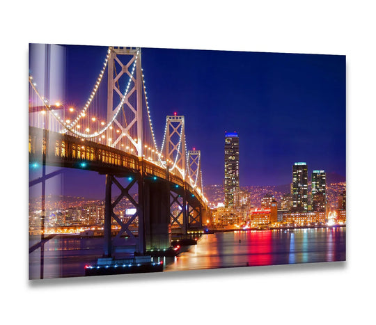 The stillness of the Bay Bridge at night reflects in the water below, an iconic cityscape scene captured in this print wall art.