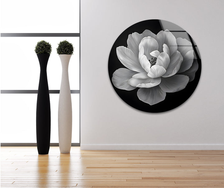 Modern black and white wall decor featuring a bold floral composition on glass wall art.