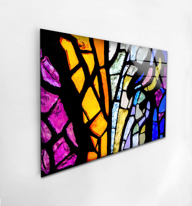 a painting of a colorful stained glass piece hanging on a wall