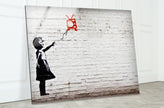 a picture of a girl with a kite on a brick wall