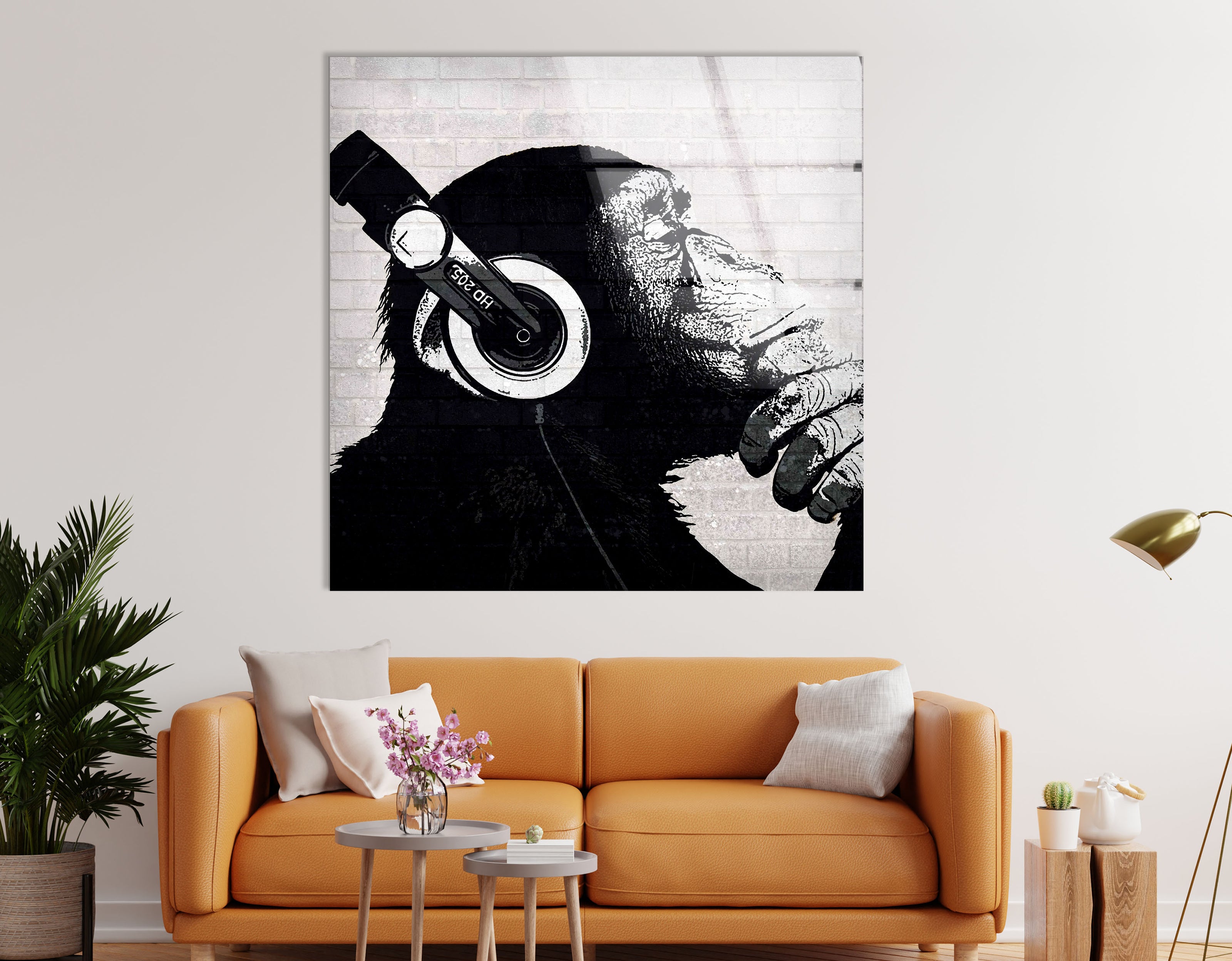 a living room with a couch and a painting of a monkey with headphones on