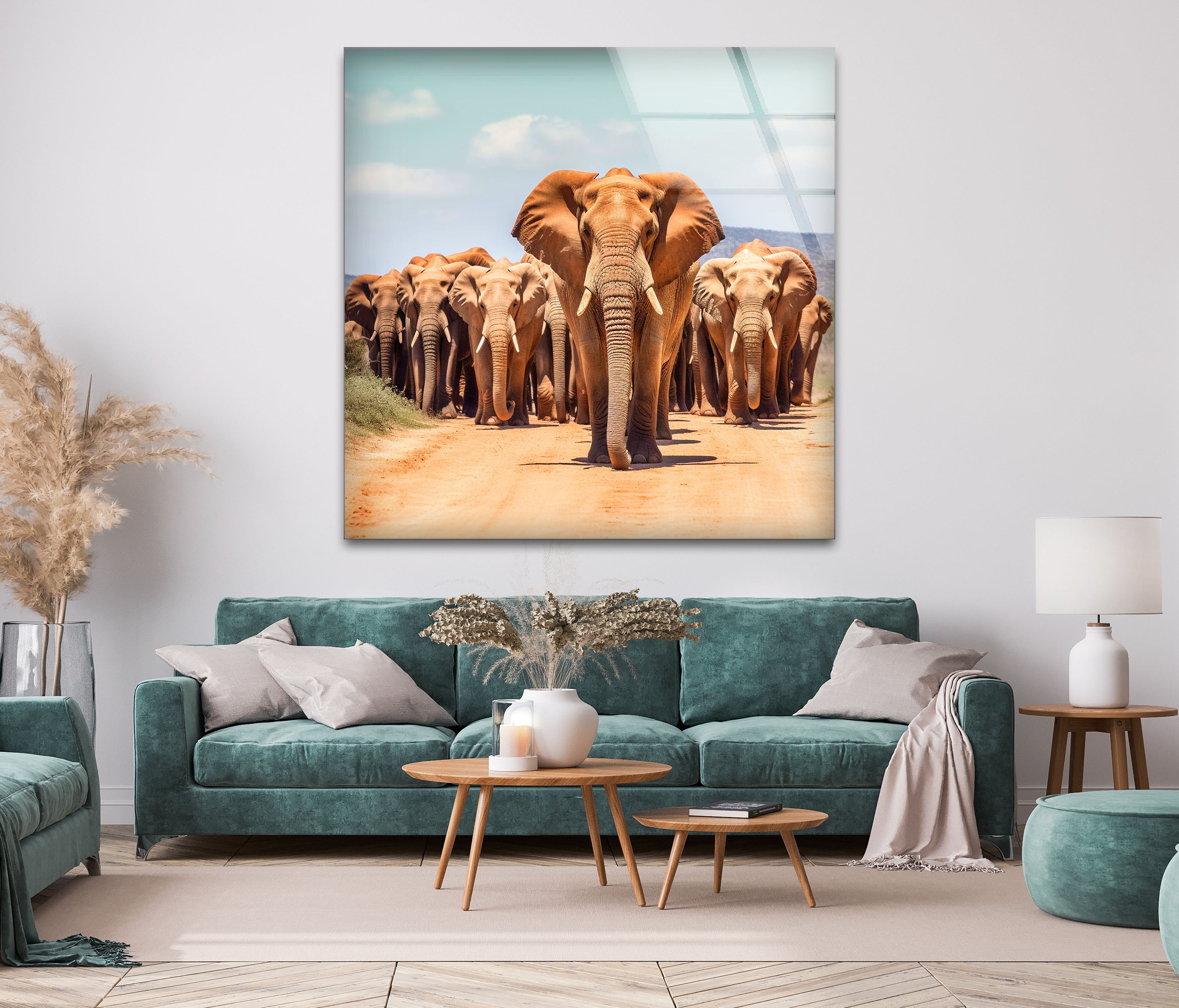 a group of elephants walking down a dirt road