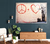 a living room with a peace sign and a painting on the wall
