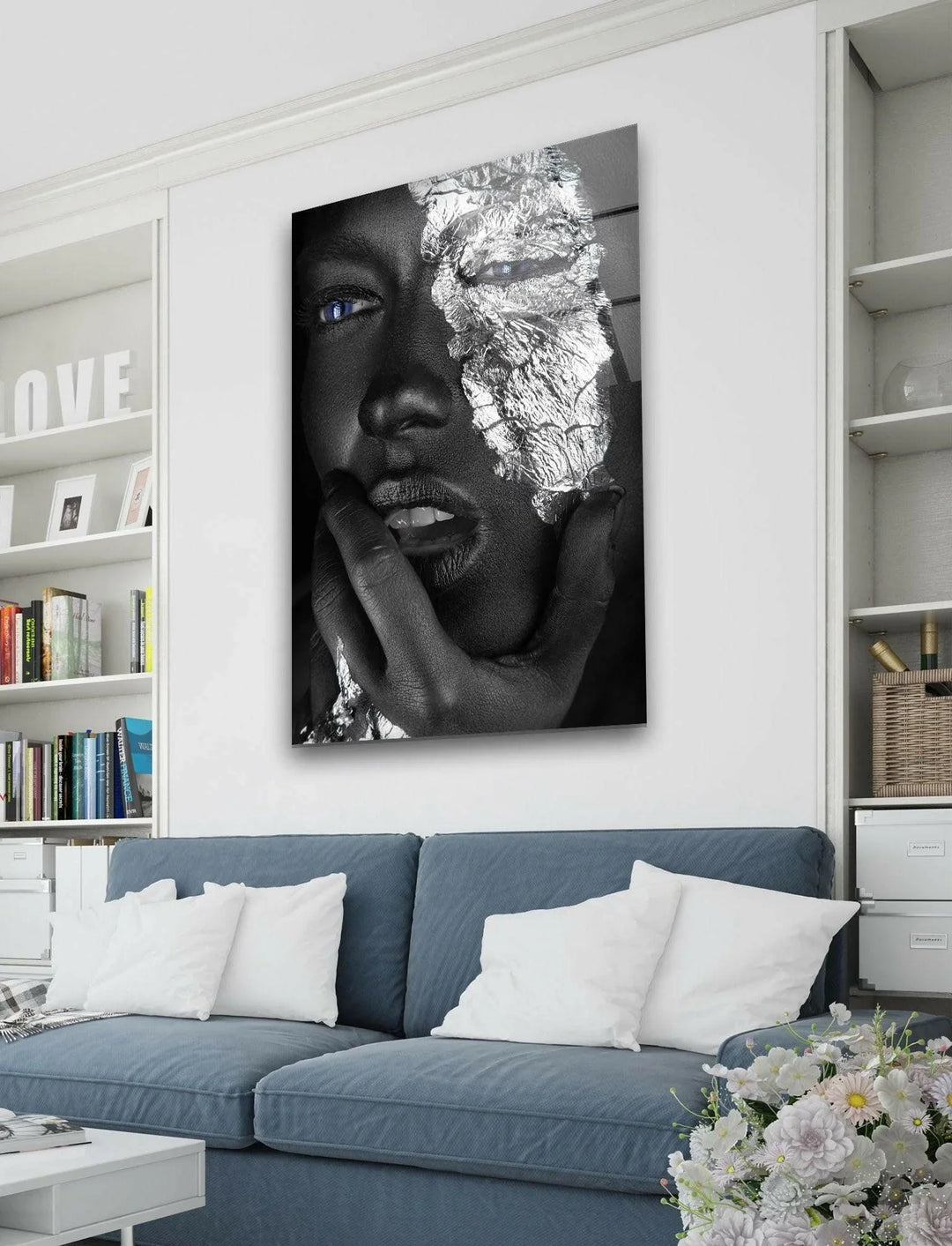 Contemporary black and white face artwork enhanced with shimmering metallic textures and blue eyes.