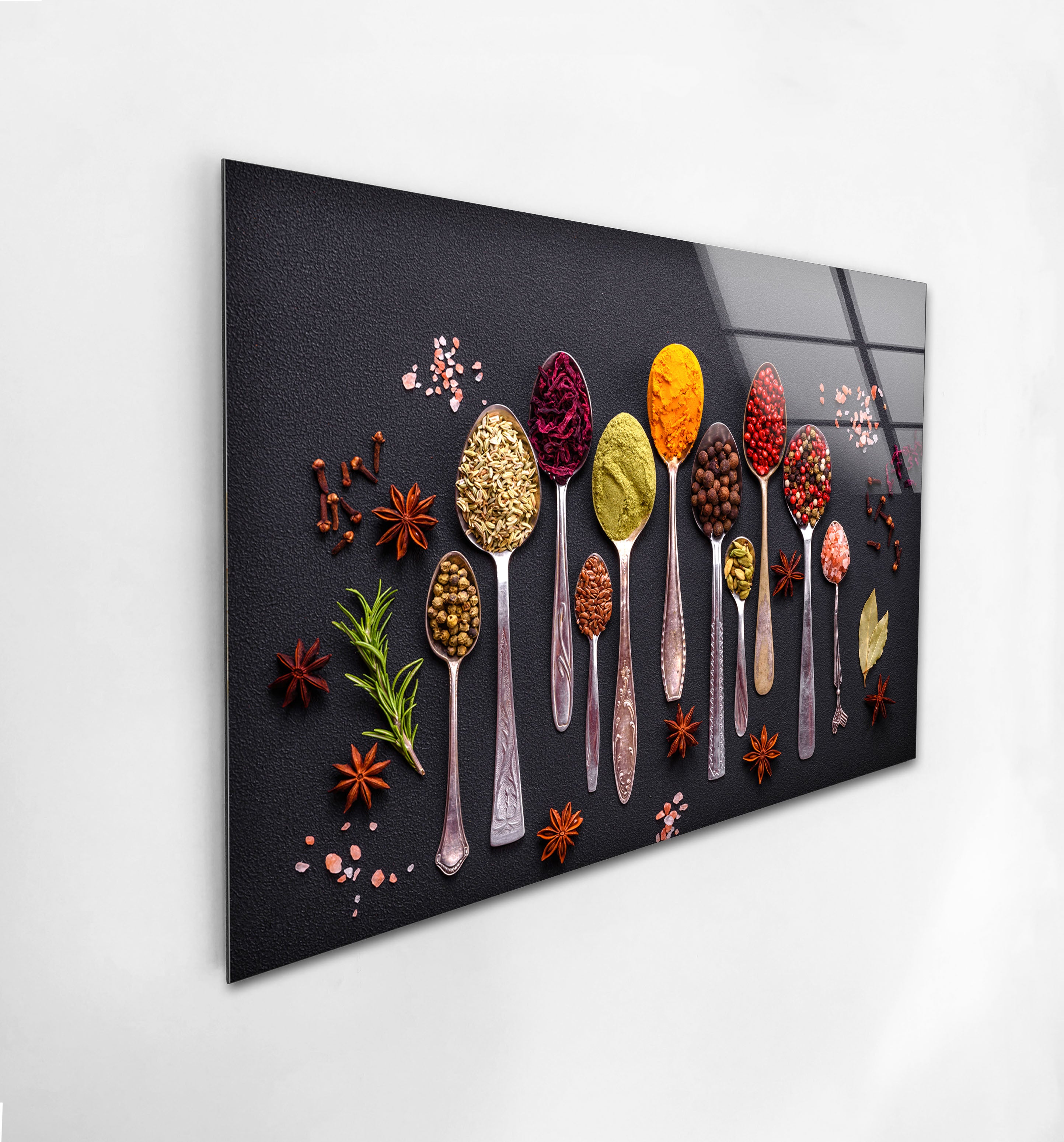 a picture of spoons and spices on a wall