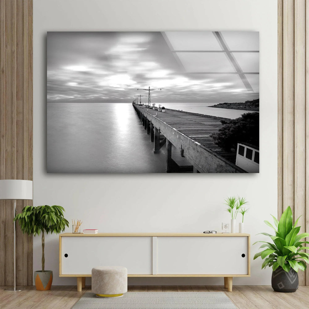 Serene monochrome seascape featuring a rustic pier reaching toward the horizon on glass décor.
