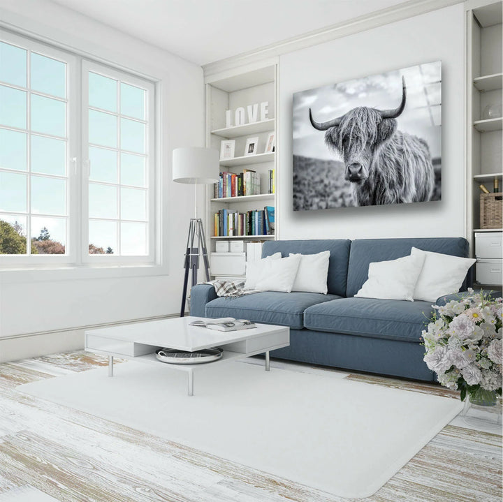 High-detail monochrome artwork of a Highland cow set against a blurred countryside.