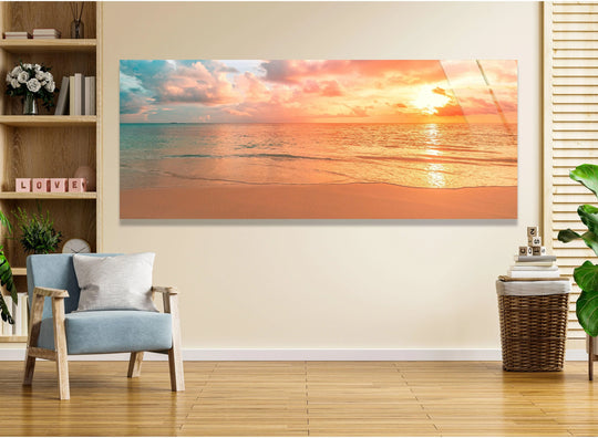 Pastel Sunset Beach landscape glass wall art displays a scenic ocean view and warm colors and is a large statement piece for modern wall decor above sofa