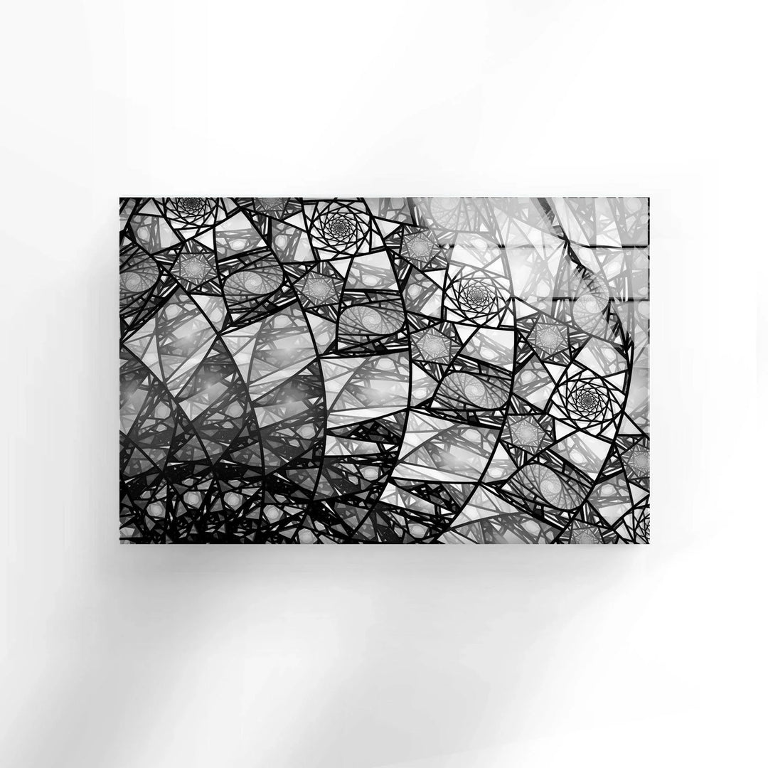 Monochrome fractal arrangement showcasing layered spirals and lines on glass panel.