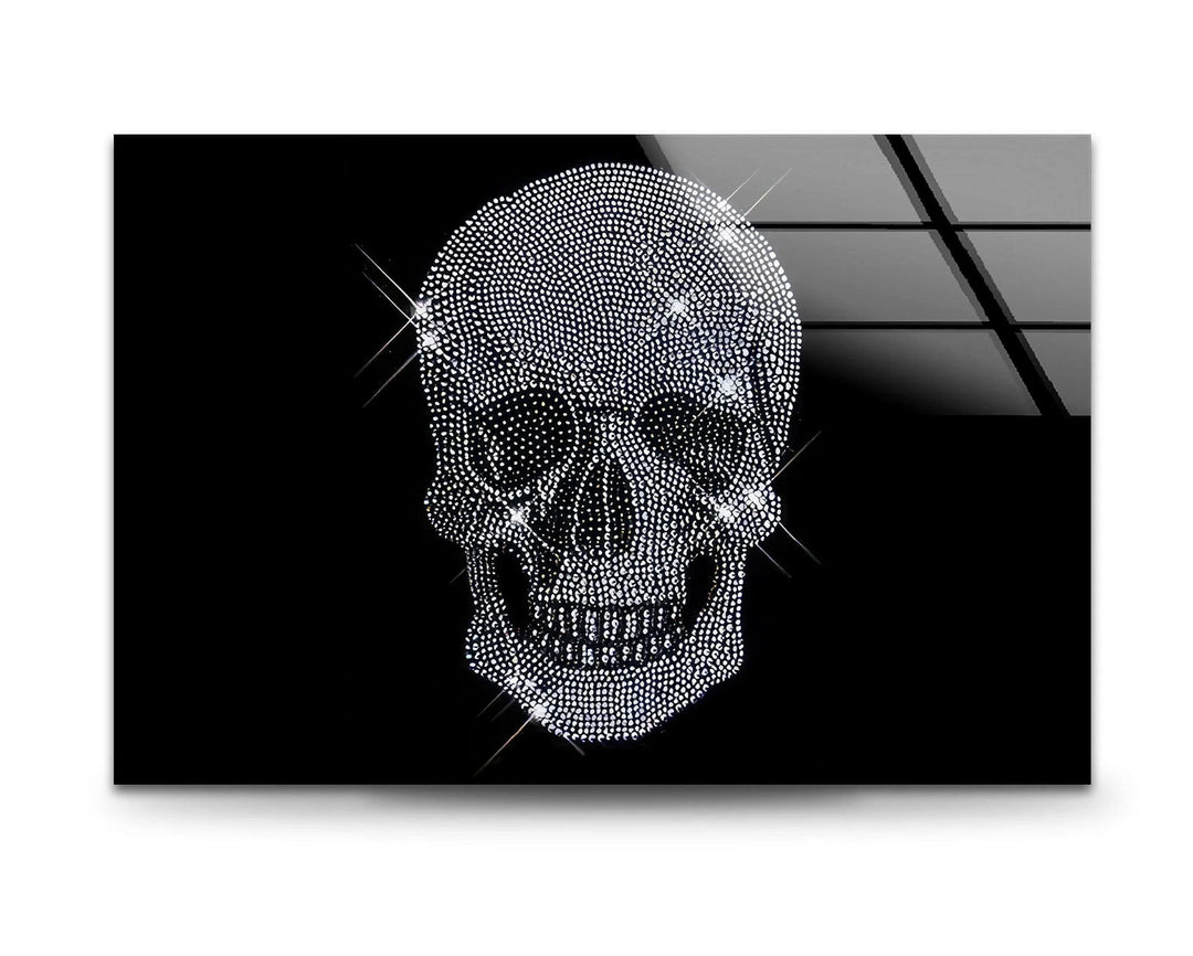 Decorative grayscale glass art of a rhinestone-covered skull glowing with bright reflections.