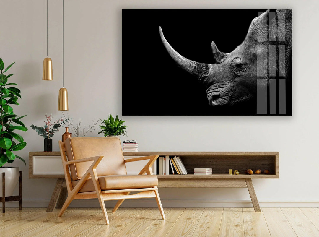 Black and white glass wall art featuring a close-up profile of a rhinoceros against a dark background.