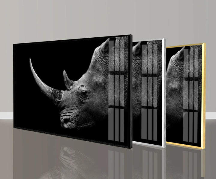 Grayscale rhino portrait on glass emphasizing the large horn and rugged skin.