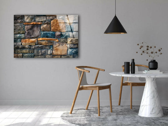 A modern dining area with a chic marble table and wooden chairs is set against a textured grey wall, complementing a striking glass art painting.