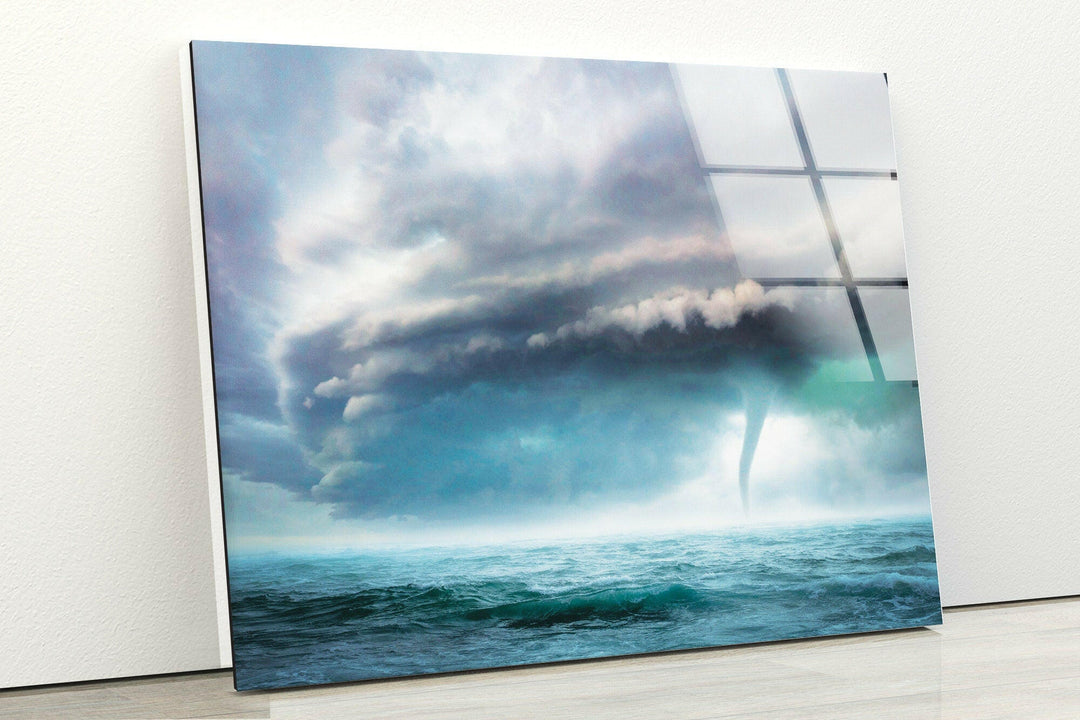 A breathtaking ocean view with a swirling tornado emerging from the sky.
