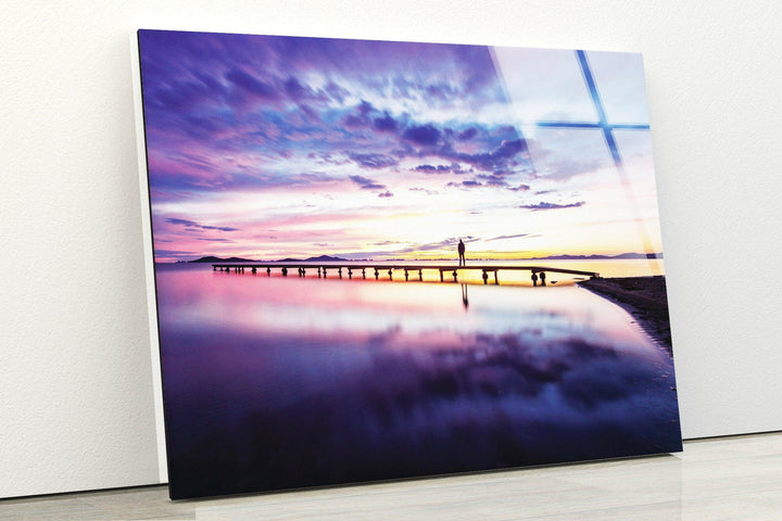 Large landscape wall art of a sunset-lit boardwalk stretching into the sea.
