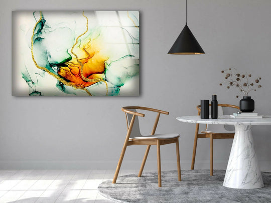 Abstract glass wall art featuring flowing green and orange shapes with metallic gold lines as unique modern wall decor.