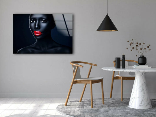 A striking abstract print wall art of a dark-skinned figure with vibrant red lips and piercing eyes against a navy background.