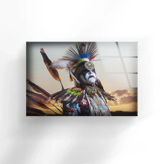 Native American warrior with vibrant feather headdress and war paint shines as the loudest element in this striking glass wall art.
