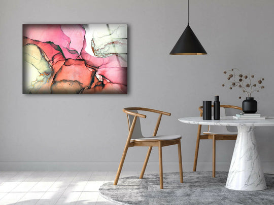 Abstract glass wall art in warm, rosy hues with hints of cool green and yellow tones evokes a soft, inviting color temperature.