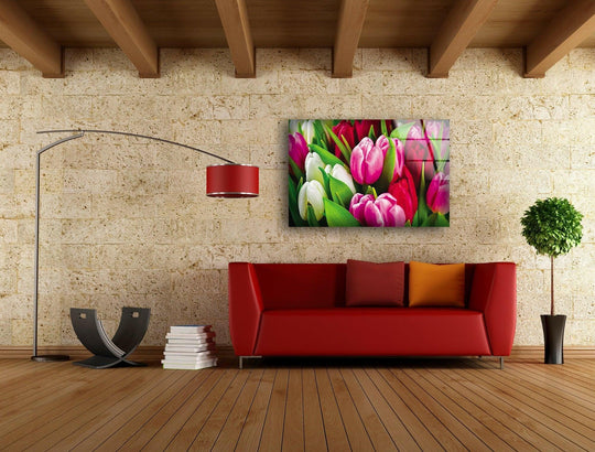 Vibrant color contrast defines this lively scene, where colorful tulips glass wall artwork pops against the muted wall and complements the bright red couch.