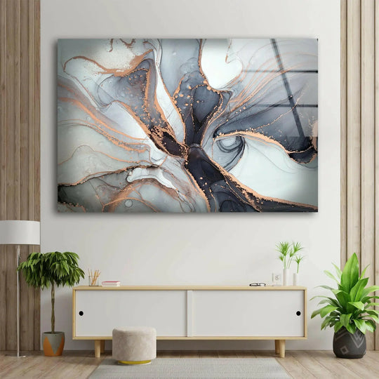 An abstract glass wall artwork of gray, black, and rose gold alcohol ink with low color saturation.
