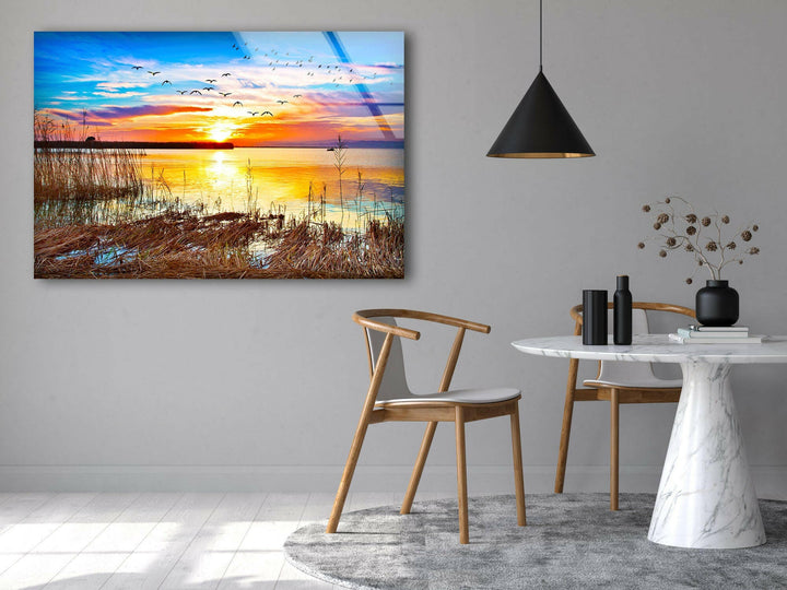 Sunset Over Still Waters with Natural Reeds – A Captivating Glass Print
