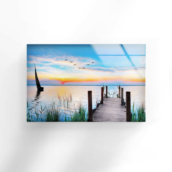 Nature paintings for sale depicting a tranquil wooden pier leading into a stunning sunset on a calm lake.

