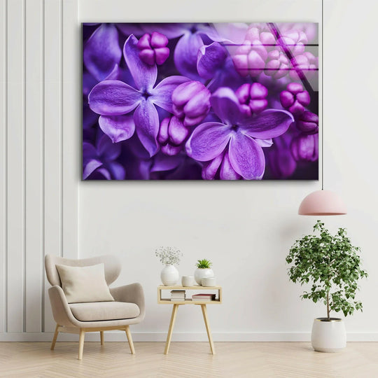 A purple lilac flower glass wall art with clean edges and borders enhances a modern living space.