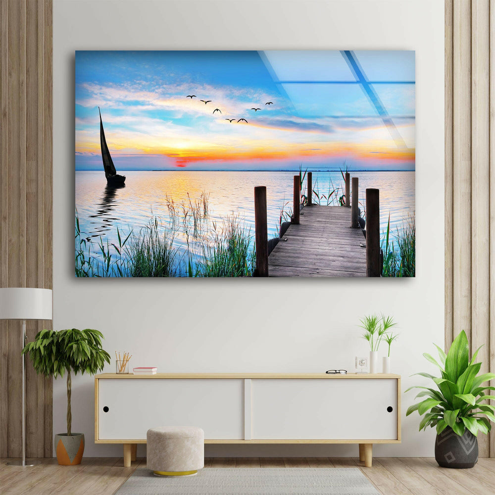 A tranquil landscape wall art showcasing a wooden pier stretching out into the serene waters at dusk.

