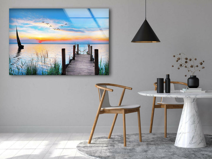 Landscape art for sale of a peaceful lakeside scene at sunset, with a quiet pier reaching into the water.
