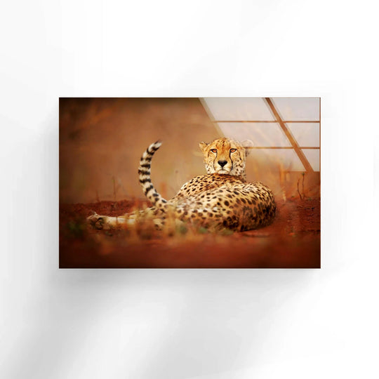 A cheetah in the savanna lies down with hyperrealistic detail, showcased on a wall art print.
