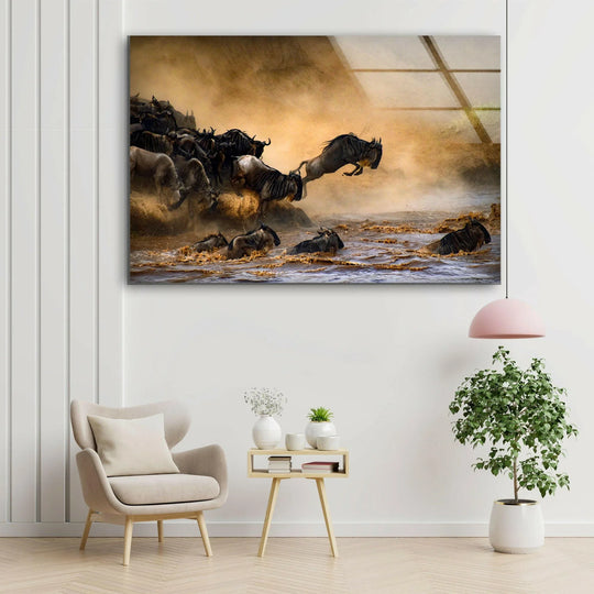 A herd of wildebeests creates layers of depth as they charge through water in this dramatic glass art scene.