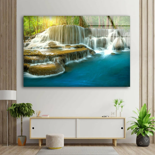 Serene Waterfall glass wall art presents a tranquil cascade in nature with flowing water and lush greenery and sunlight and brings a sense of peace
